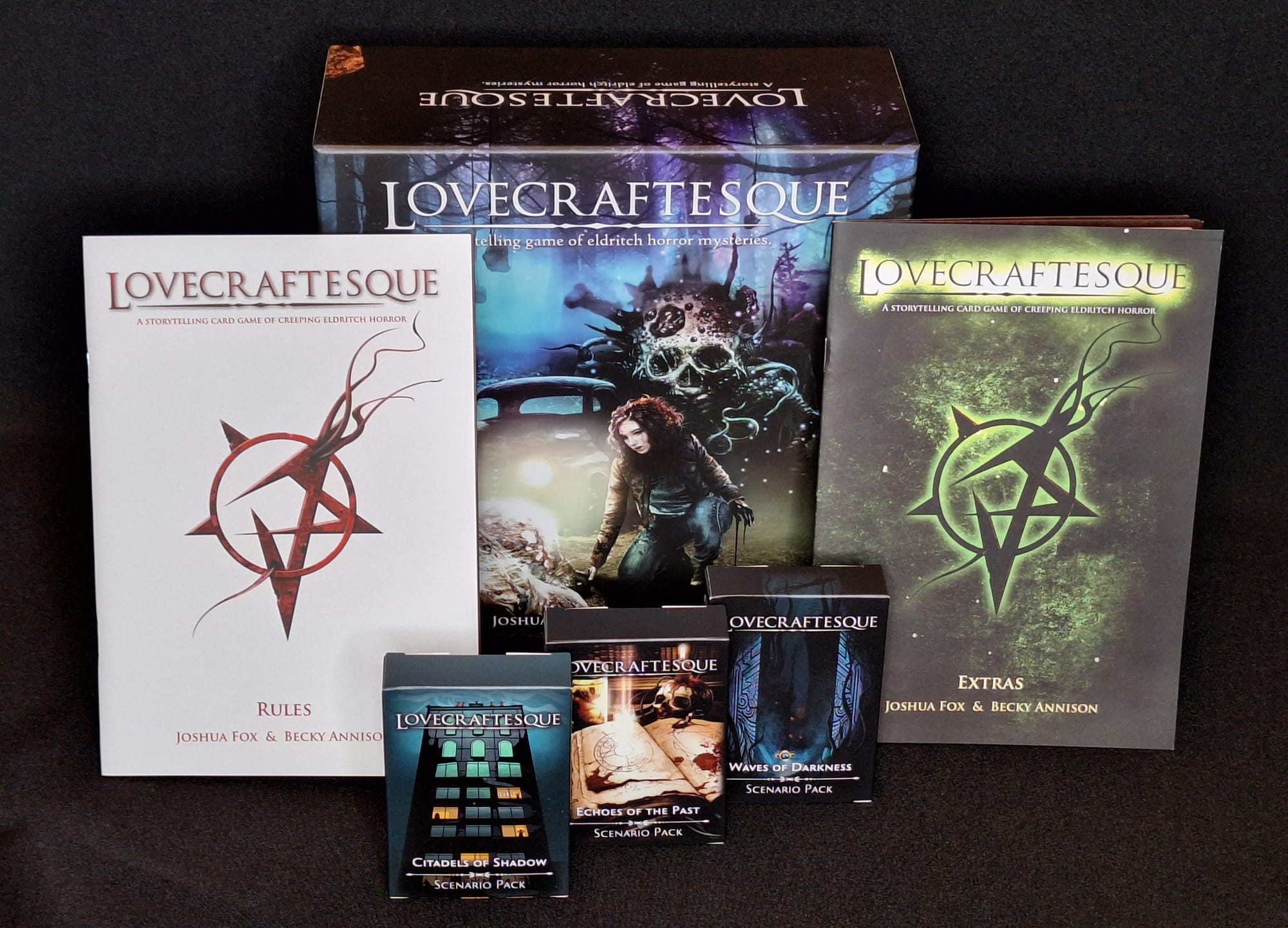 The chonky Lovecraftesque box, alongside the rules manuals and expansions.