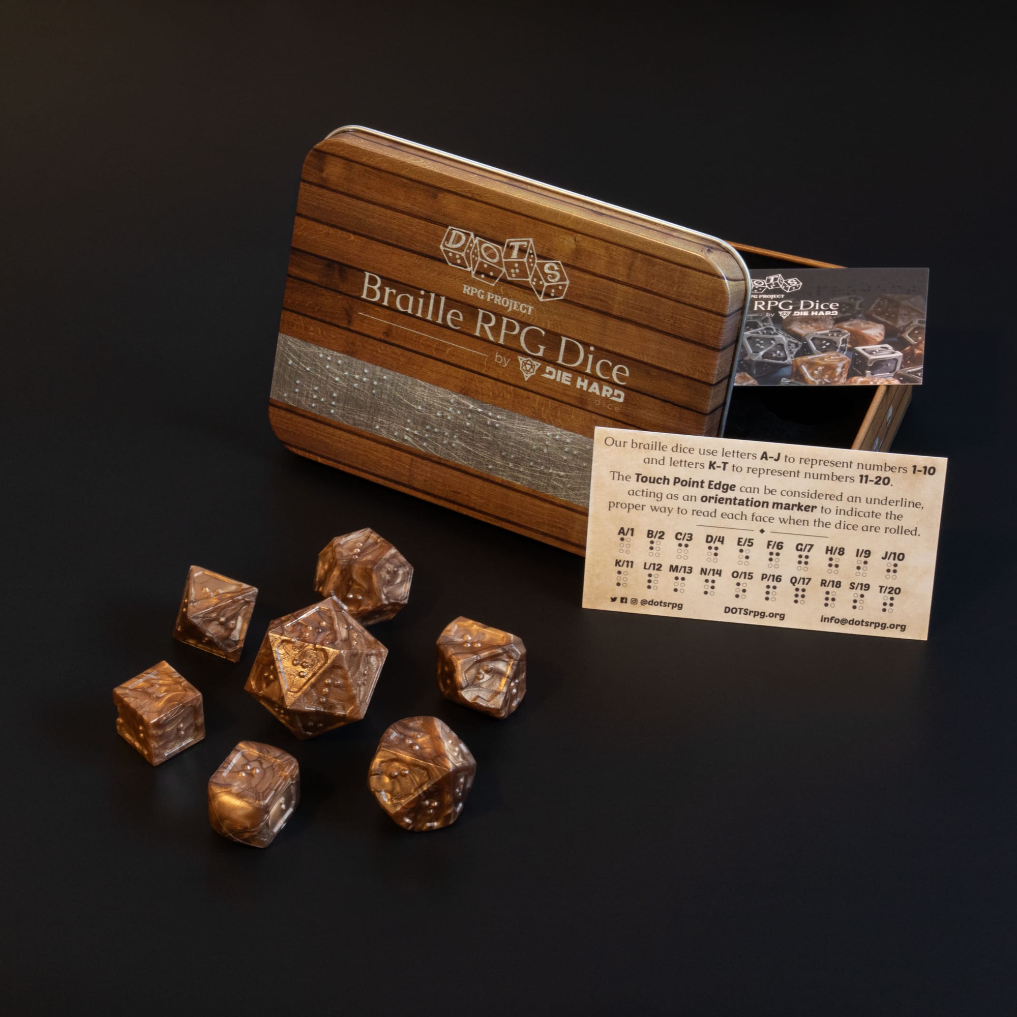 7 piece set of acrylic Braille RPG Dice in Molten Bronze with metal case and sighted braille guide.