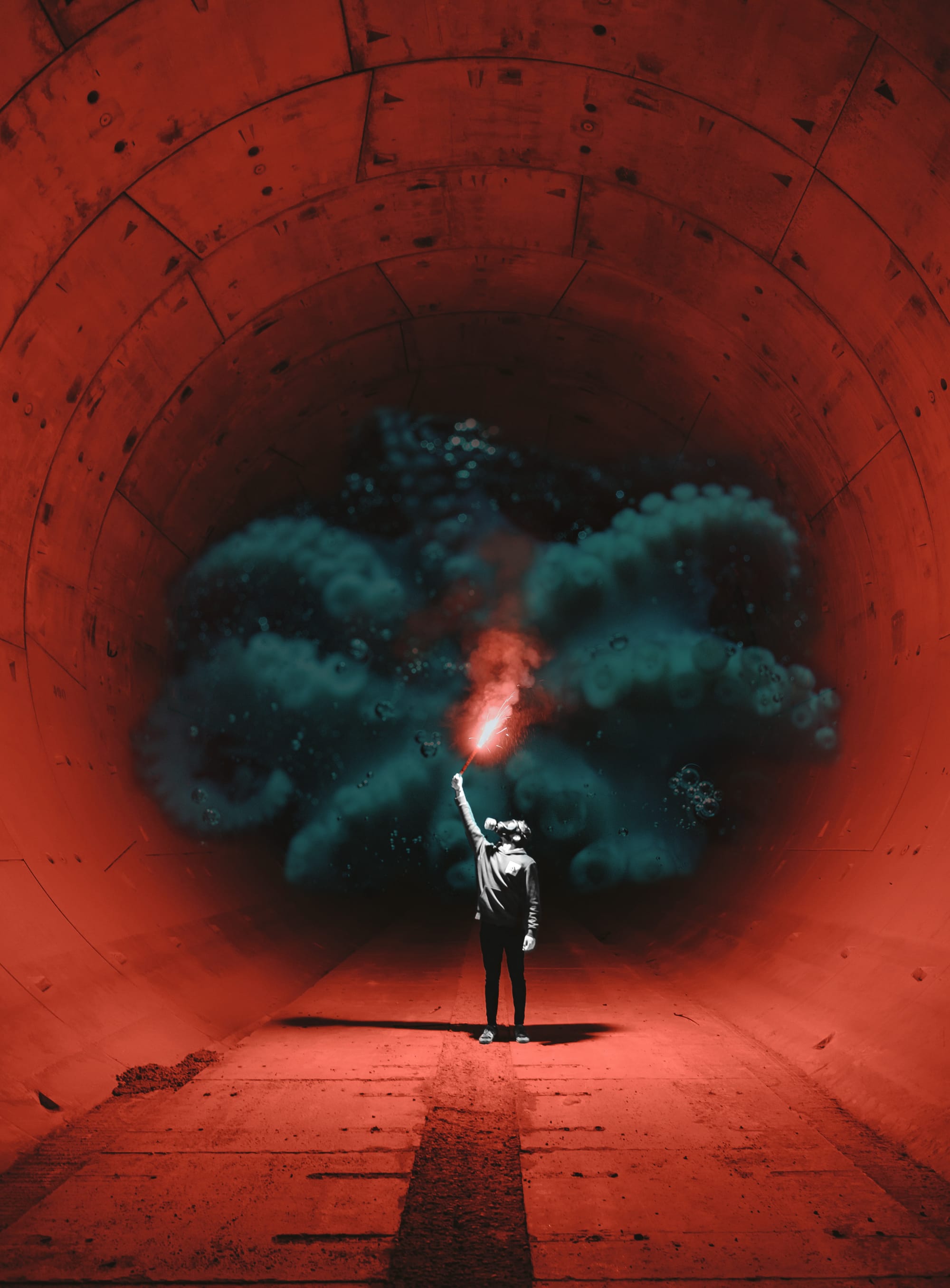 A single rebel in a tunnel, wearing a gas mask and holding a glowing flare