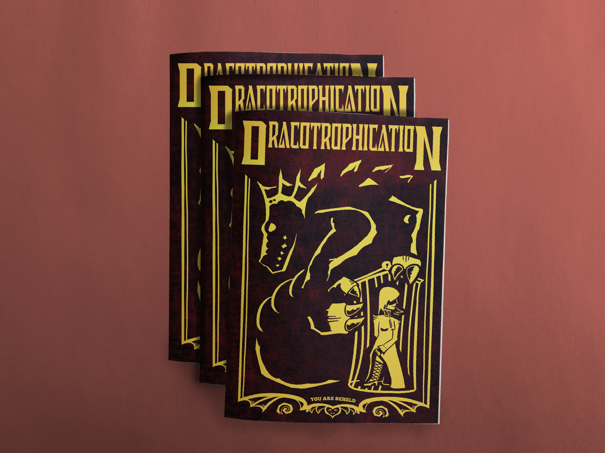 Three mockups of Dracotrophication. The cover has the logo, a dragon lording over a trapped and sexy maiden in a cage, and a flourish with wings and a cat-faced heart on the bottom. Toward the bottom is the text 'You Are Beheld', referring to the creative collective which created the game.