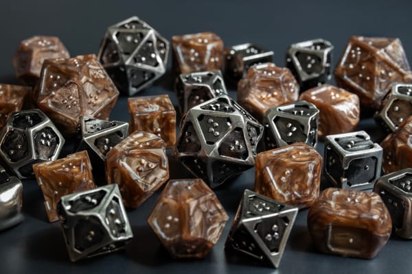 Close up view of a pile with multiple braille polyhedral dice. 