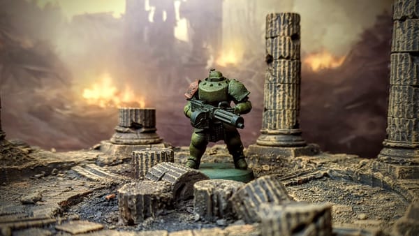 A photo of a green armoured miniature figure in brownish ruins.