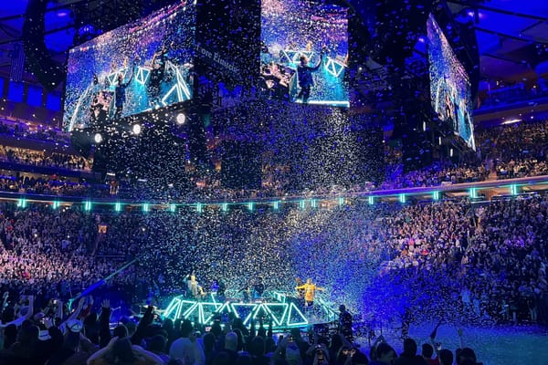 Dimension 20 live show stage being covered in confetti in a packed out theater