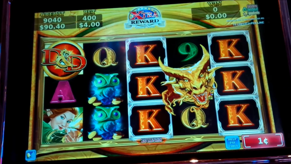 Digital screen of a slot machine with five columns of three symbols, showing cards, owls and a gold dragon.