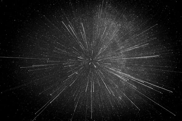 stars shooting across space in black and white