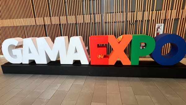 Decoration spells GAMA in white block letters and EXPO in color, set inside the Kentucky International Convention Center.